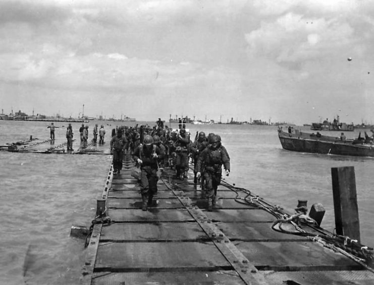 troops coming ashore on Mulberry A on D-Days Omaha Beach at Saint Laurent Sur Mer
