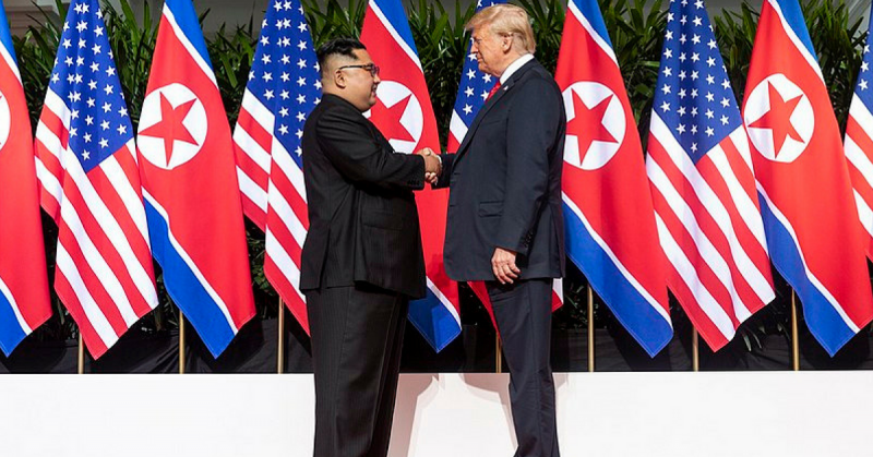 Kim and Trump shaking hands at the red carpet during the DPRK–USA Singapore Summit