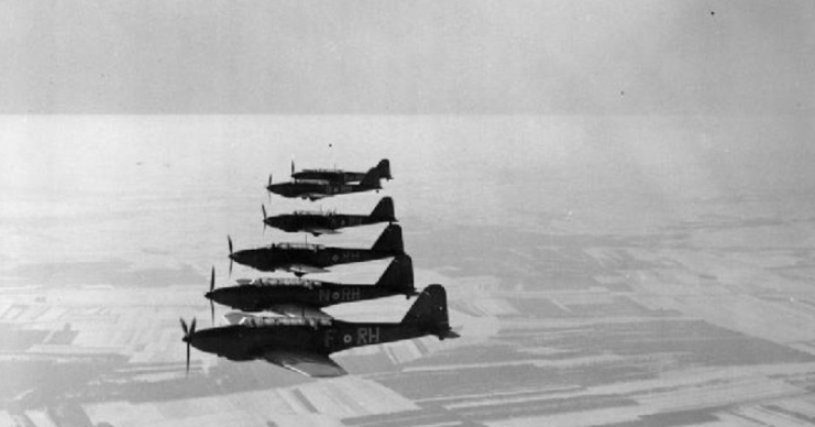Six Fairey Battles of No. 88 Squadron RAF based at Mourmelon-le-Grand, flying in starboard echelon formation over the snow-covered French countryside.