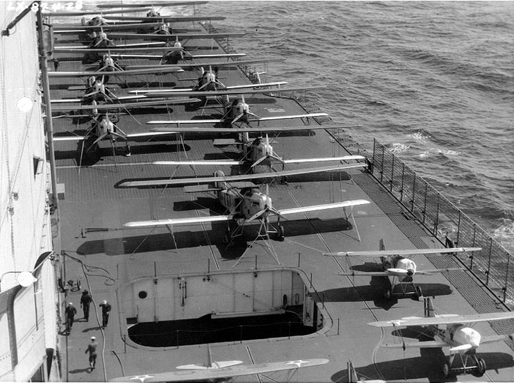 USS Lexington (CV-2)- Curtiss F6C fighters (lower right) and Martin T3M torpedo planes on the carrier’s flight deck, as she arrives off San Diego, California, on her maiden cruise, 4 April 1928.