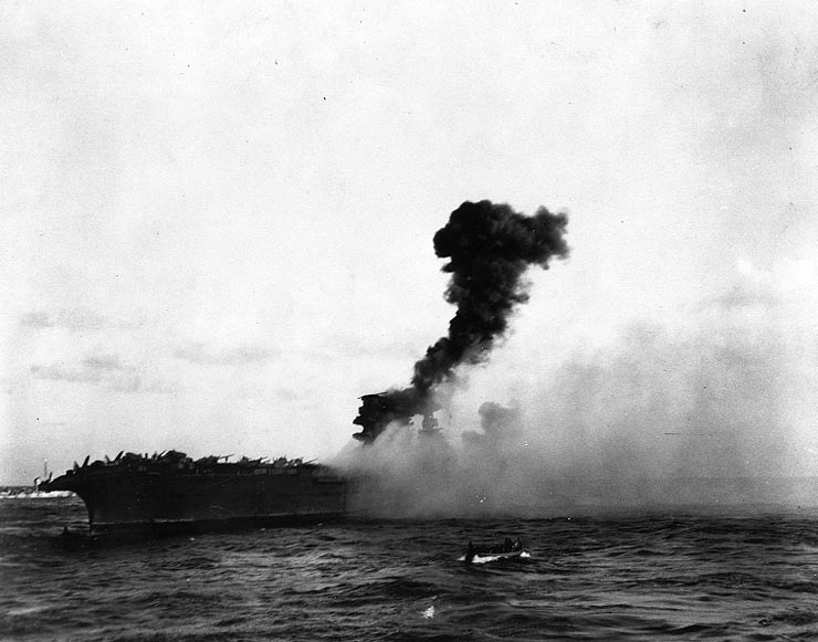 View of an explosion amidships on the U.S. Navy aircraft carrier USS Lexington (CV-2), while she was being abandoned during the afternoon of 8 May 1942.