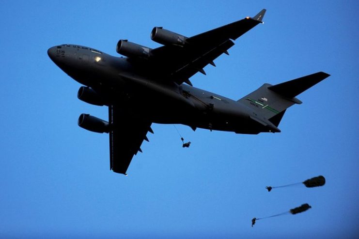 A U.S. Air Force C-17 Globemaster III drops paratroopers from the 82nd Airborne Division into a drop zone during a Joint Forcible Entry Exercise at Fort Bragg, N.C.