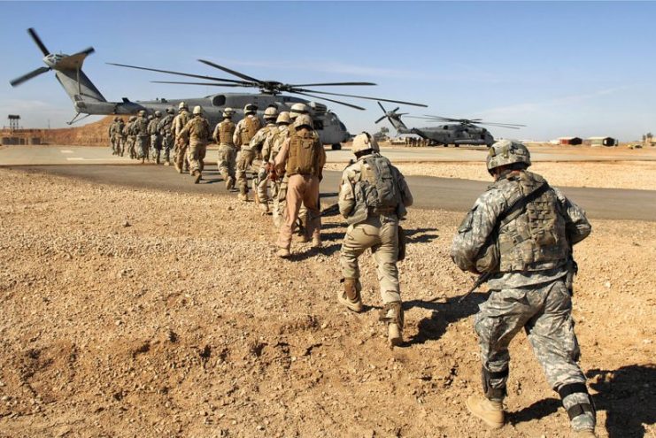 U.S. Army and Iraqi army soldiers board a Marine Corps CH-53 Super Stallion helicopter in Iraq.