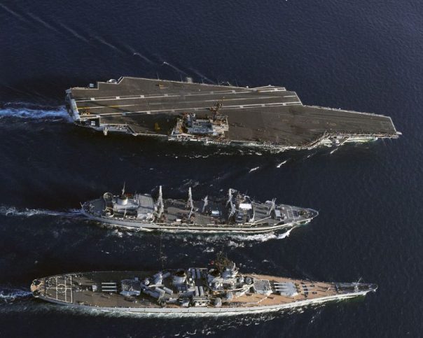 An aerial starboard view of the fleet oiler USNS Kawishini (T-AO-146), center, the battleship USS Missouri (BB-63), bottom, and the aircraft carrier USS Kitty Hawk (CV-63), participating in an underway replenishment operation, 25 July 1986.