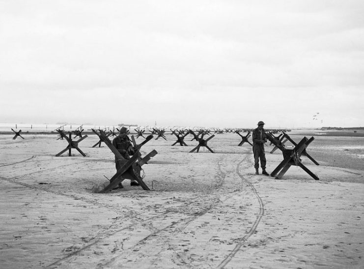 Operation Overlord: Royal Navy Commandos at La Riviere preparing to demolish two of the many beach obstacles designed to hinder the advance of an invading army.