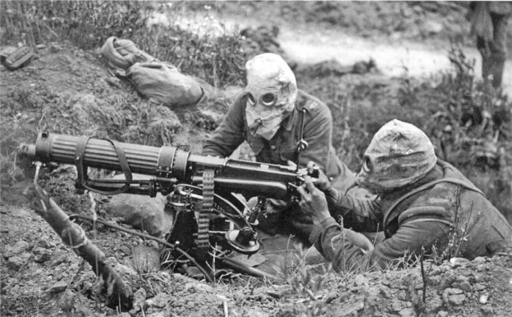 British Vickers machine gun crew wearing PH-type anti-gas helmets.