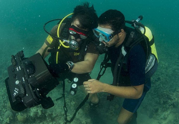 Explosive ordnance disposal 2nd Class Justin Kwon, assigned to Commander, Task Group (CTG) 56.1, and a member of the Bahrain Coast Guard, conduct underwater searches using an underwater imaging system.