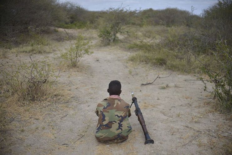 An SNA soldier rests on the frontline with his rocket-propelled grenade (RPG) launcher beside him during an advance towards the town of Buur-Hakba on February 24, 2013. By AMISOM Public Information CCO