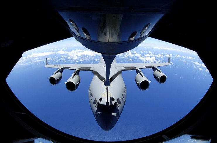 A C-17 Globemaster refuels through the boom of a Boeing KC-135 Stratotanker.