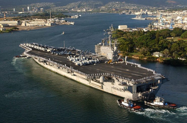 Ronald Reagan is aided by harbor tugs as it enters Pearl Harbor, Hawaii, for a port visit on 28 June 2006.