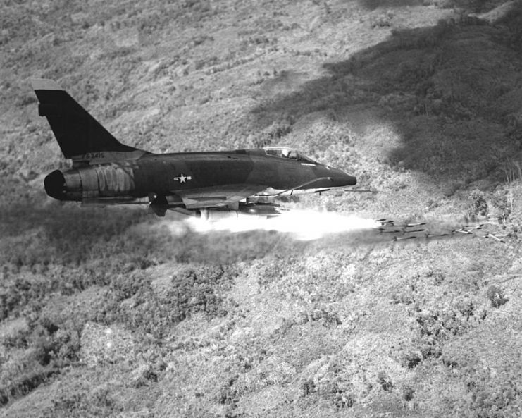 A U.S. Air Force North American F-100D-85-NH Super Sabre aircraft fires a salvo of 2.75-inch rockets against an enemy position in South Vietnam in 1967. This aircraft was lost with its pilot, 1Lt Clive Jeffs, after an engine failure near Nha Trang on 12 March 1971.