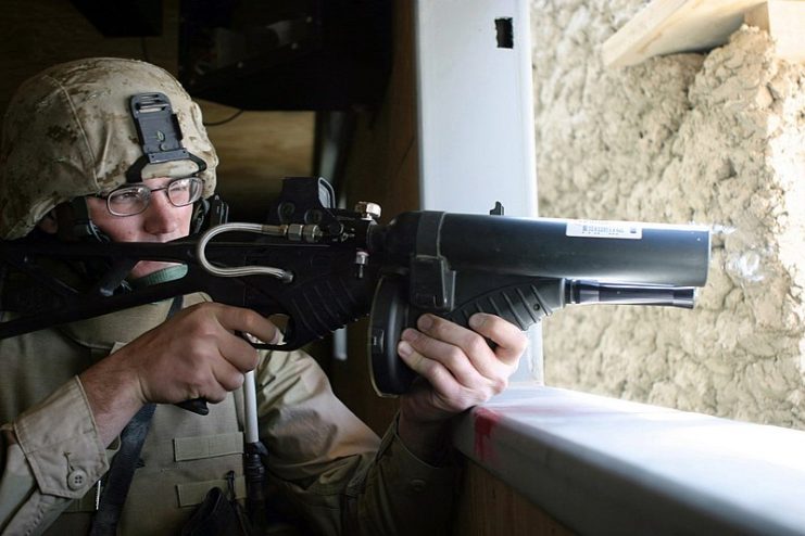 A U.S. Marine aiming a nonlethal FN 303 fitted with an EOTech holographic weapon sight in June 2006.