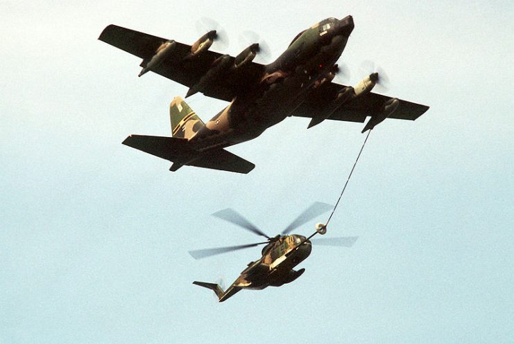 A U.S. Air Force Lockheed HC-130P Hercules aircraft refueling a HH-3E Jolly Green Giant helicopter during exercise “Sentry Castle ’81” near Fort Drum, New York (USA), 9 July 1981. Both aircraft were assigned to the 102nd Aerospace Rescue & Recovery Squadron, 106th Rescue Group, New York Air National Guard.