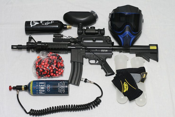 A paintball marker and related equipment, including ammunition and a protective mask.By Bob McGrath CC BY 2.0