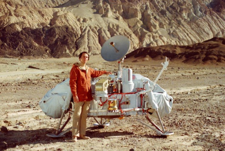 Sagan with a model of the Viking lander that would land on Mars.