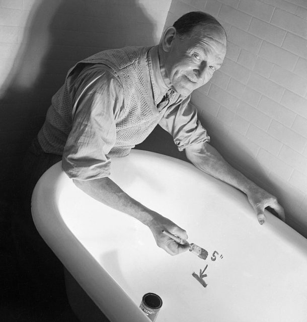 A man draws a line in his bath as part of a British Government’s drive to encourage the public to ration their use of hot water and conserve fuel supplies during the Second World War.