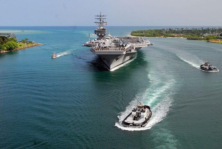 Sailors aboard Ronald Reagan man the rails as the supercarrier arrives at her new homeport in San Diego, California, on 23 July 2004.