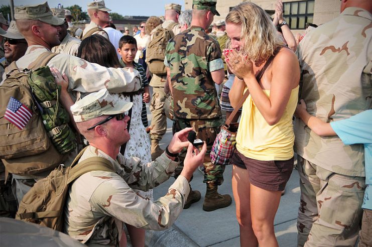 Jon Sanders, assigned to Naval Mobile Construction Battalion (NMCB) 133, proposes to his girlfriend during a homecoming celebration