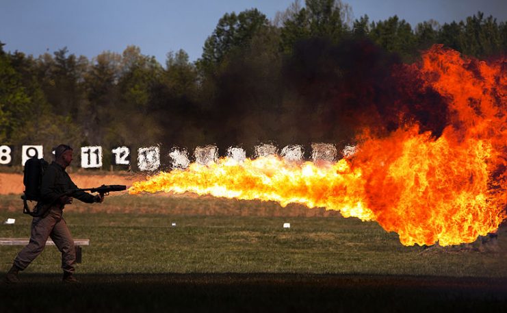 Retired Gunnery Sgt. Thomas E. Williams, director of the United States Marine Corps Historical Company, fires a World War II flame thrower during the Fire Weapons From Marine Corps History event at Marine Corps Base Quantico, Va., April 13, 2011
