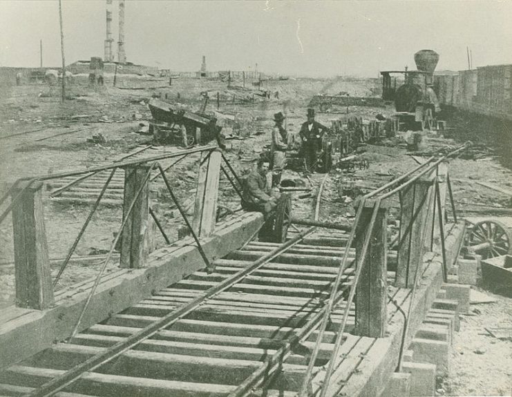 A group of men stand near the Manassas Railroad Junction railroad tracks in 1862 with a train in the background.Photo: AlbertHerring CC BY 2.0