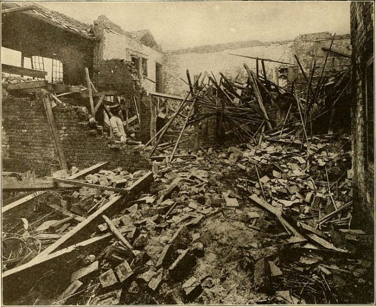 A mother and son view the remains of their home after an air raid in London.1919