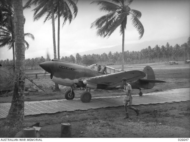 A P-40E-1 piloted by the ace Keith “Bluey” Truscott, commander of No. 76 Squadron RAAF, taxis along Marsden Matting at Milne Bay, New Guinea in September 1942.
