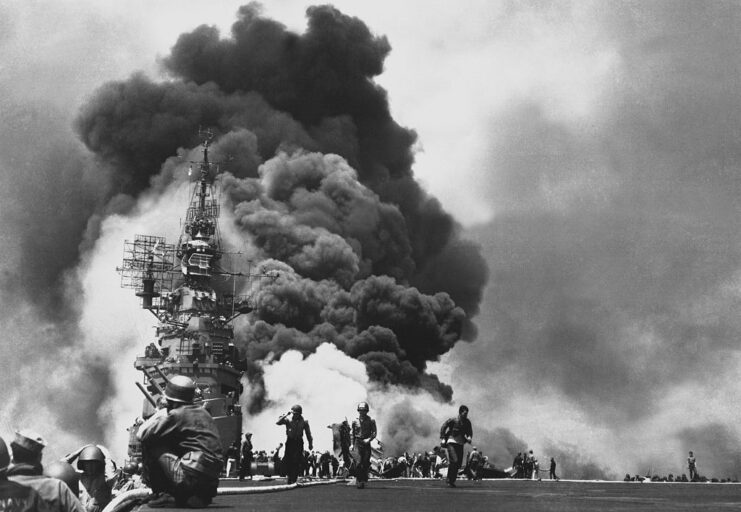 Crewmen running away from a fire on the flight deck of the USS Bunker Hill (CV-17)