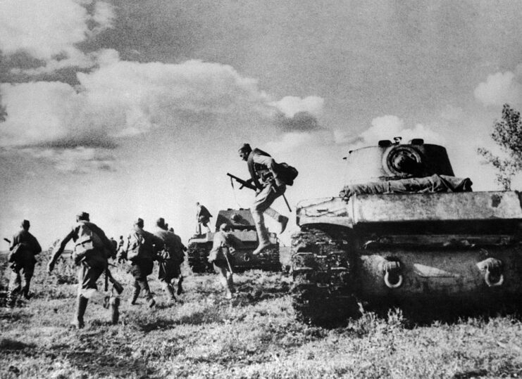 Red Army soldiers leaping from tanks