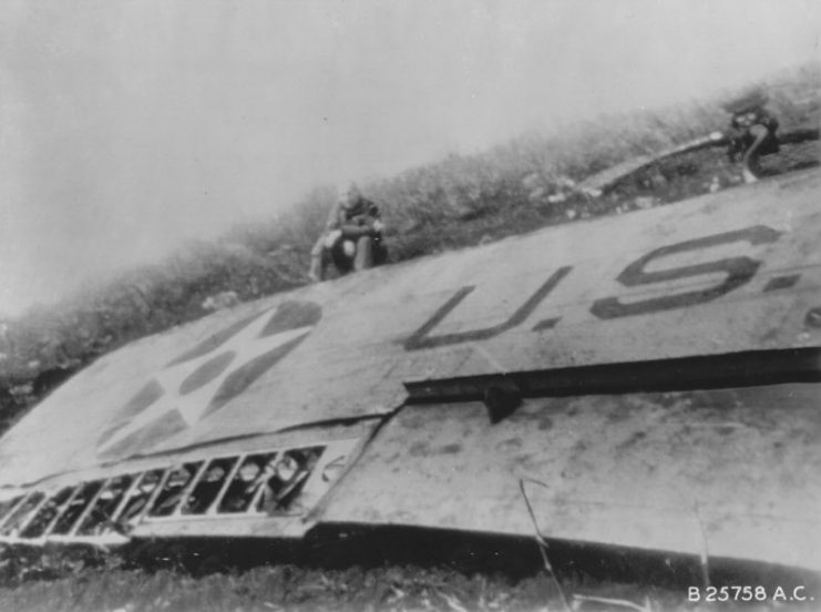 James Doolittle sitting by the wing of his wrecked B-25 Mitchell bomber, China, 18 April 1942.