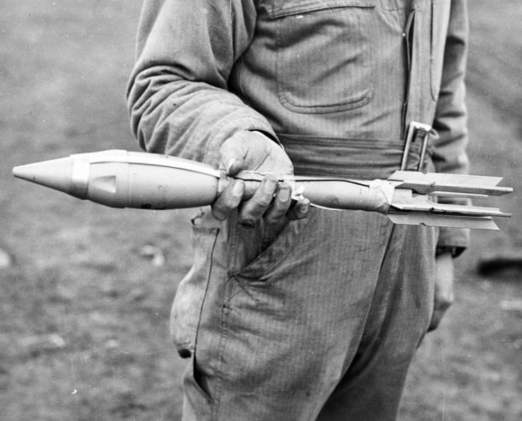 Person holding a M6 rocket for a bazooka