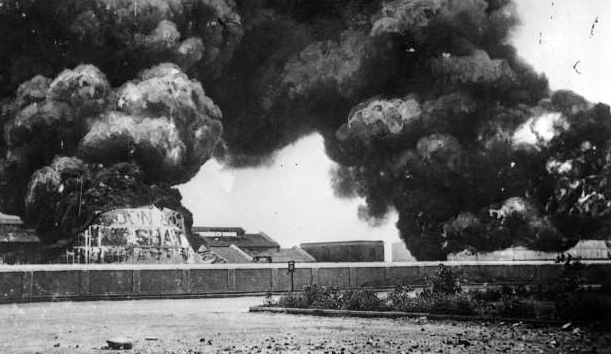 Oil tanks on fire in the harbor of Madras (Chennai, India) following the bombardment by German light cruiser S.S. Emden on 22 September 1914