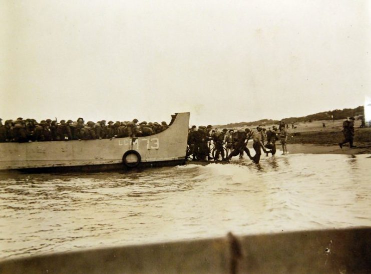 British troops landing near Algiers from landing barges which have brought them from the transports lying offshore.