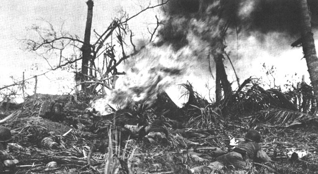 Marines engaging Japanese positions on Guam with a flamethrower.