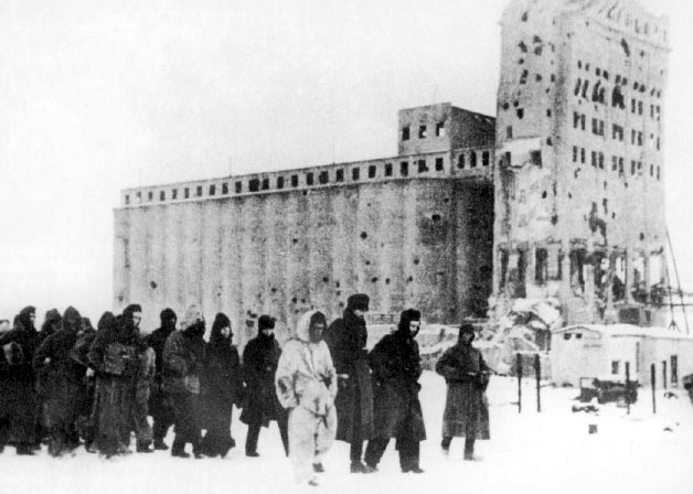 German soldiers as prisoners of war. In the background is the heavily fought-over Stalingrad grain elevator.