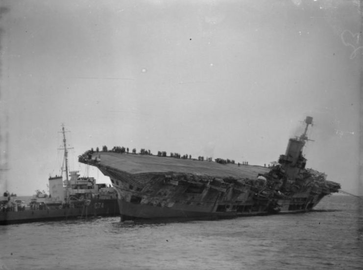 Legion moving alongside the damaged and listing Ark Royal to take off survivors