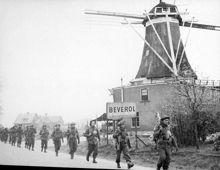 II Canadian Corps troops of the Régiment de Maisonneuve advancing along a road