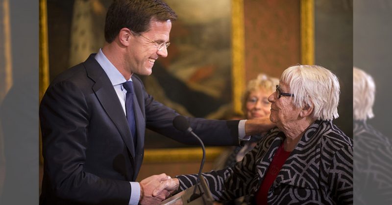 Dutch Prime Minister Mark Rutte congratulates Truus Menger-Oversteegen with her award