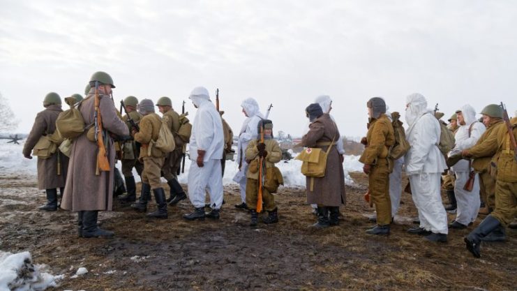 Group of Russian Soviet Armed soldiers, re-enactors during reenactment of World War II battle.