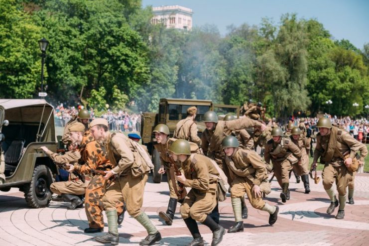 Gomel Belarus Running Reenactors In Soldiers Uniform. Reenactment Scene WW2 Battle