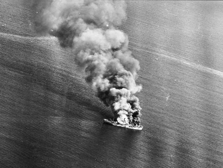 A Japanese cargo ship burns off Luzon, Philippine Islands after being attacked by U.S. carrier planes.