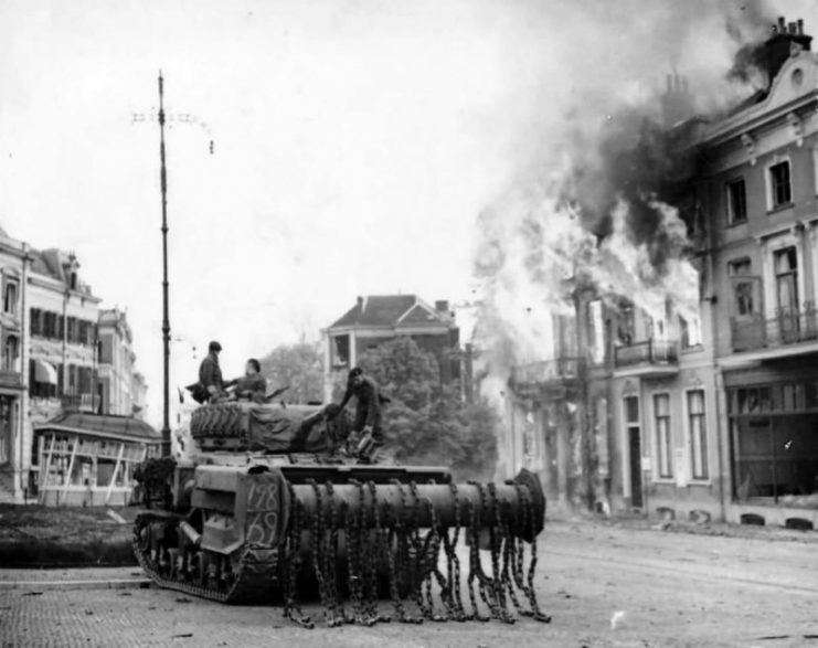 M4 Sherman Flail Tank Moves Up Through The Blazing Town Arnhem 1945