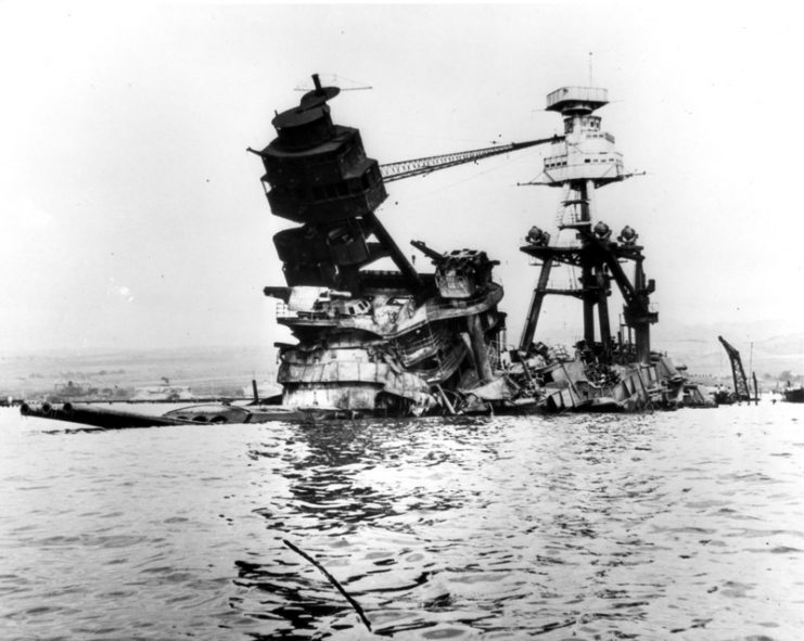 The burned-out, sunken wreck of USS Arizona (BB-39), photographed some days after the attack.