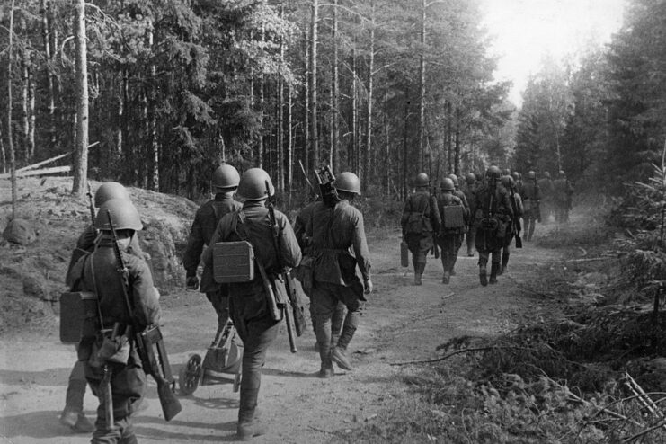 Red Army soldiers walking along a path in the middle of a forest