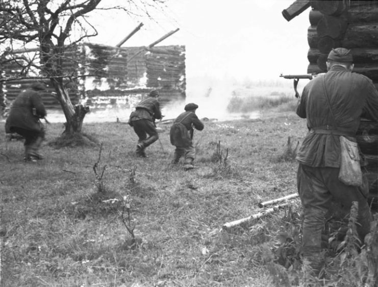 Soviet partisans take on a burning village trying to drive away German punitive expedition