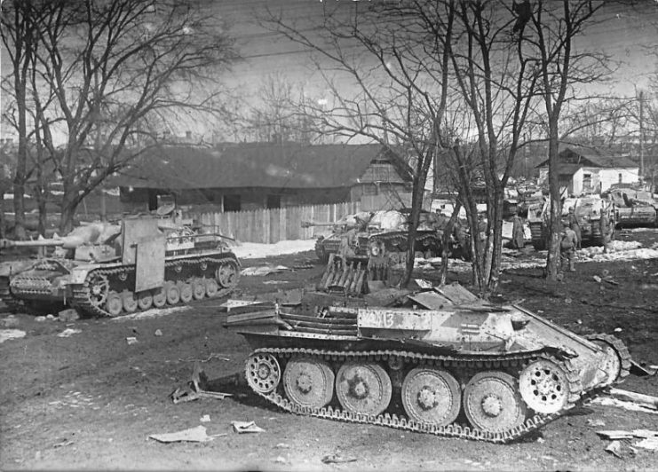 Sturmgeschutz IV and III. Wreckage of a Flakpanzer 38(t) in the foreground