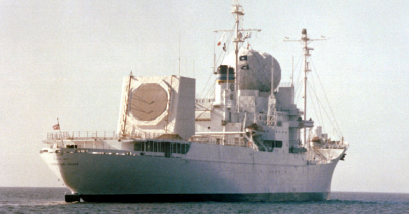 A starboard quarter view of the missile range instrumentation ship USNS Observation Island (T-AGM-23) underway during exercise Cobra Judy, an exercise to test the ship's seaworthiness. Observation Island, which has been undergoing modifications, is now equipped with a phased-array radar turret on its stern.
