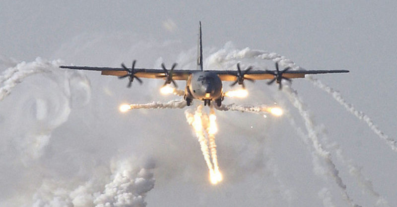 A British C-130J Hercules aircraft launches defensive countermeasures prior to being the first coalition aircraft to land on the newly reopened military runway at Baghdad International Airport.