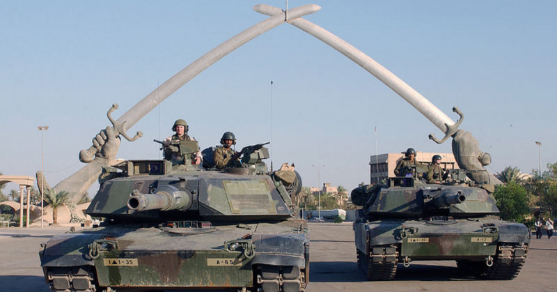 U.S. Army M1A1 Abrams tanks and their crews pose for a photo in front of the 