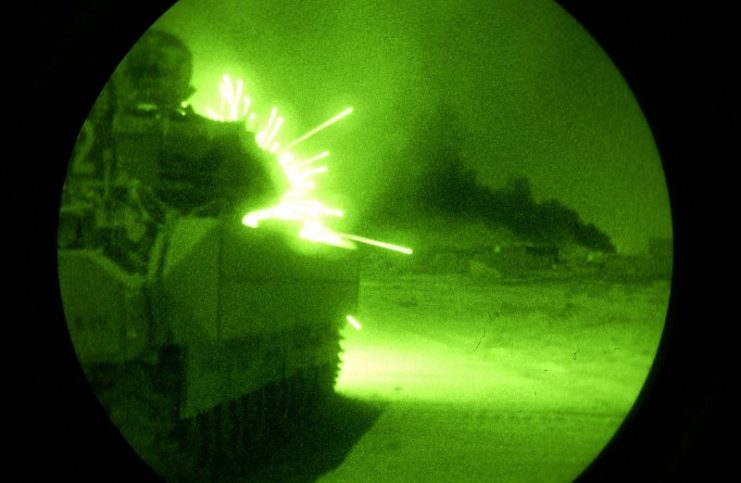 An Army Bradley Fighting Vehicle opens fire with its 25-millimeter machine gun on anti-coalition forces during Operation Baton Rouge in Samarra, Iraq, on Sept. 30, 2004.