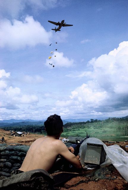 An American Caribou cargo plane parachutes urgently needed supplies into a besieged Green Beret camp. Photo: manhhai CC BY-NC 2.0